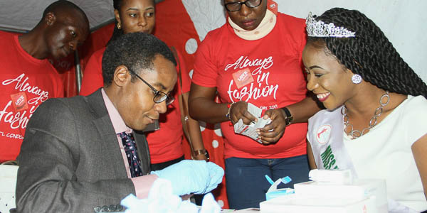 AHF Nigeria supporting HIV testing and prevention with condom promotion sharing the HIV test facts and frequently asked questions during an event